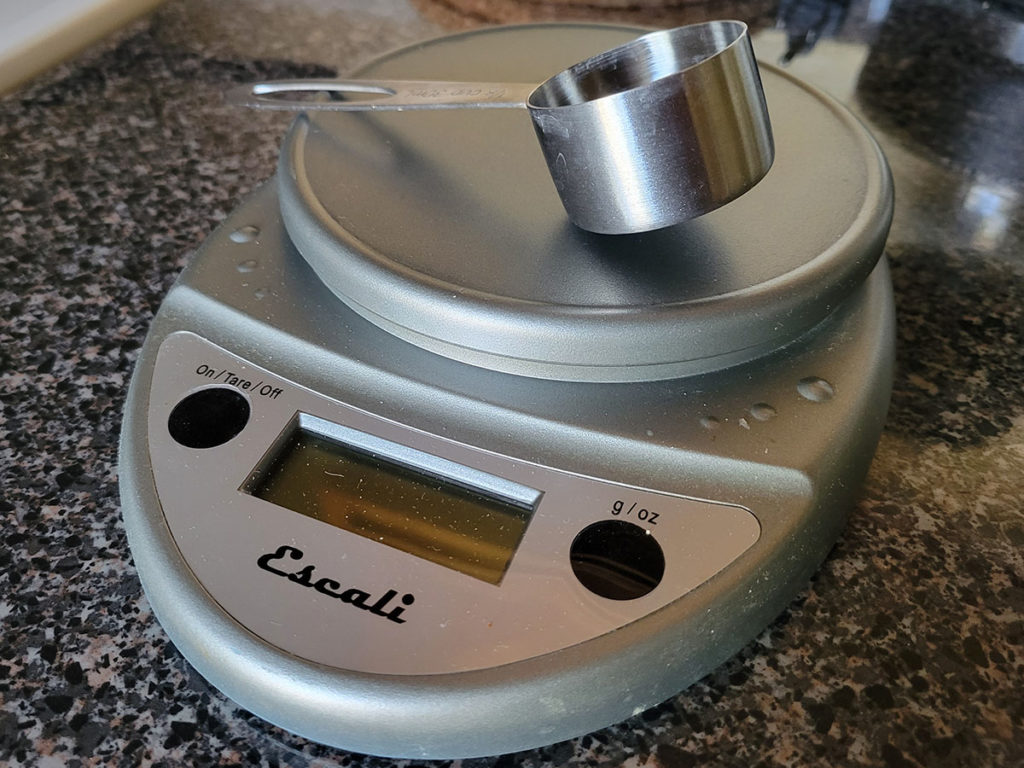 My well-used digital kitchen scale and dedicated coffee scoop